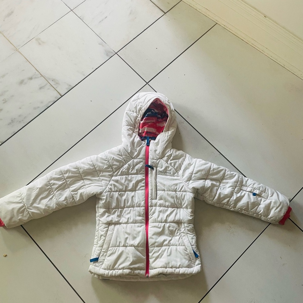 Patagonia Kids White Puffer Jacket with pink detail in hood.